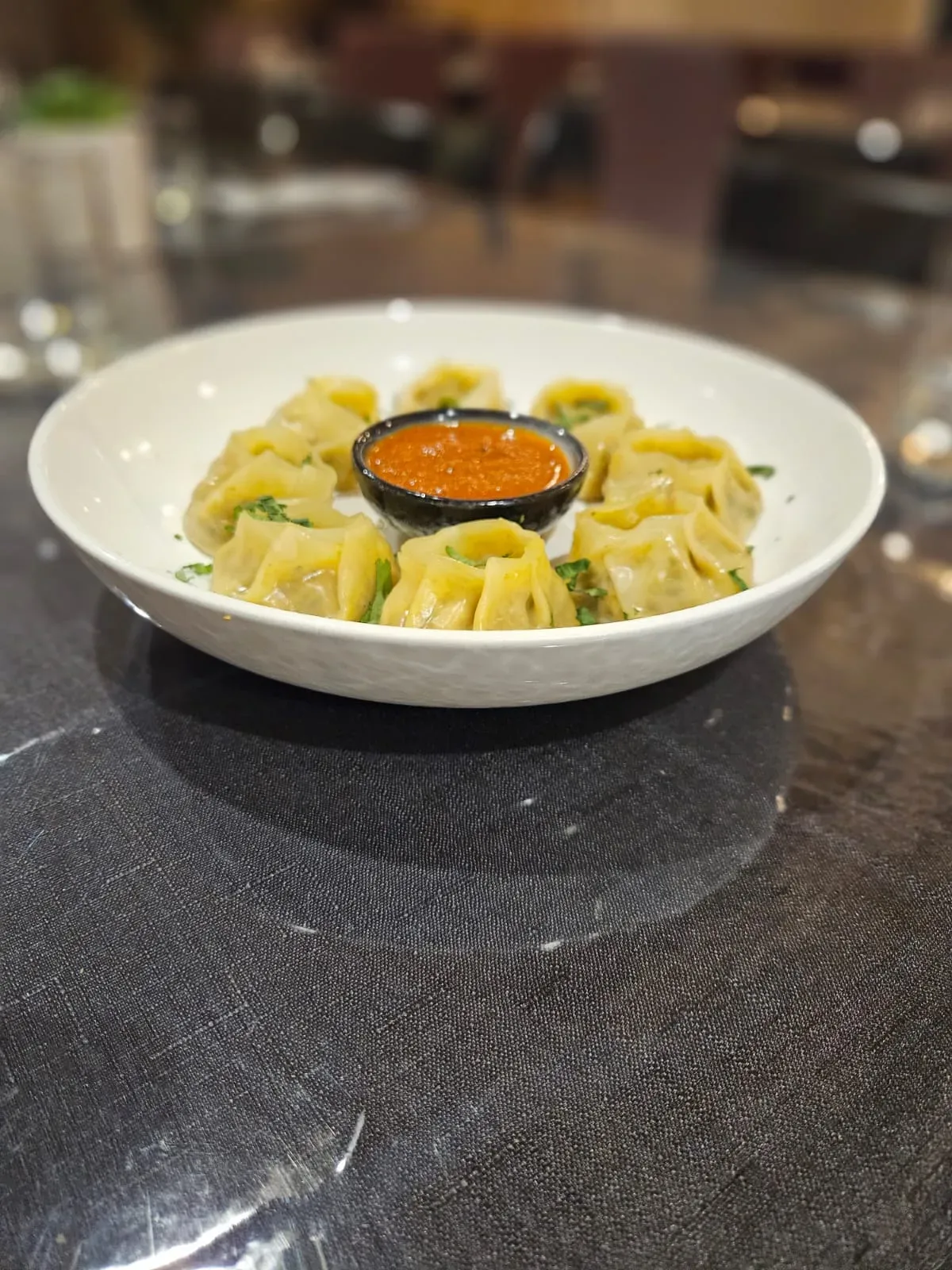 Steamed dumplings plated at TASSIE FLAME in Cambridge