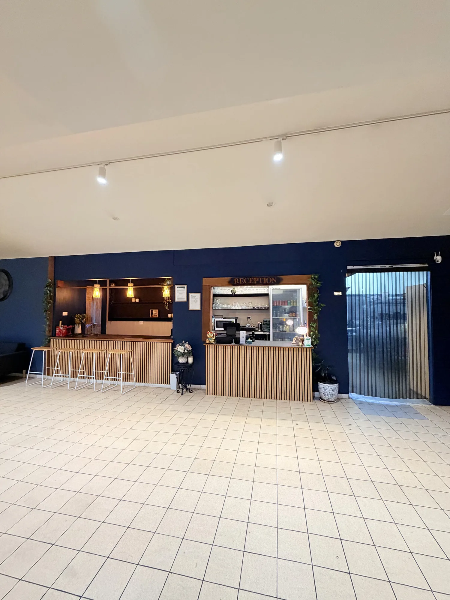 Reception desk and entrance at TASSIE FLAME